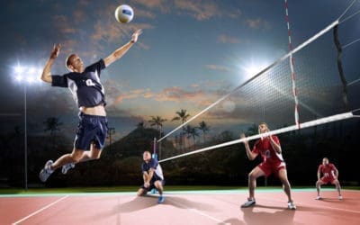 Professional volleyball players in action on the night court